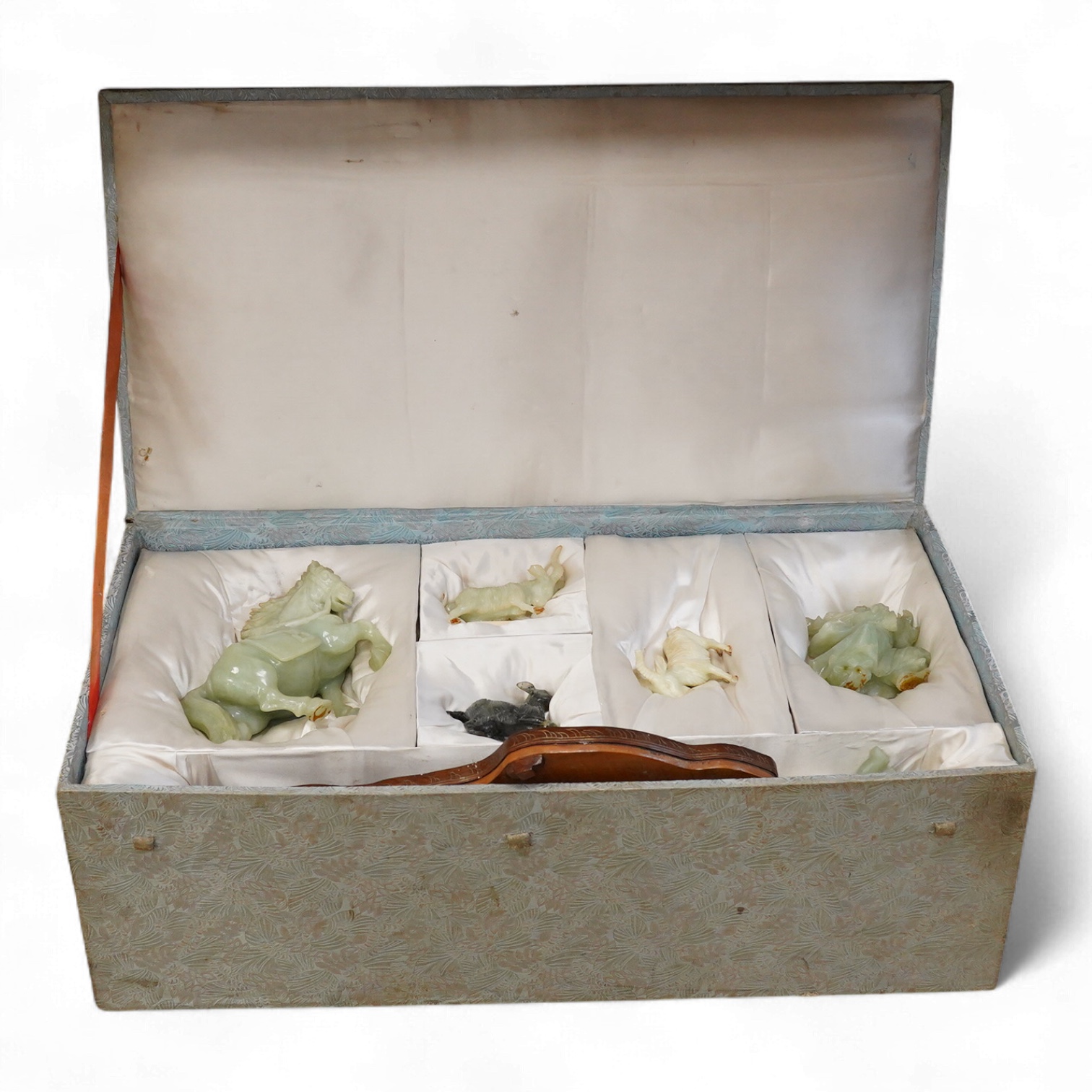 A Chinese silk brocade box containing six Chinese hard stone coloured carved animals and a wooden and metal inlaid stand, largest a horse 19cm wide